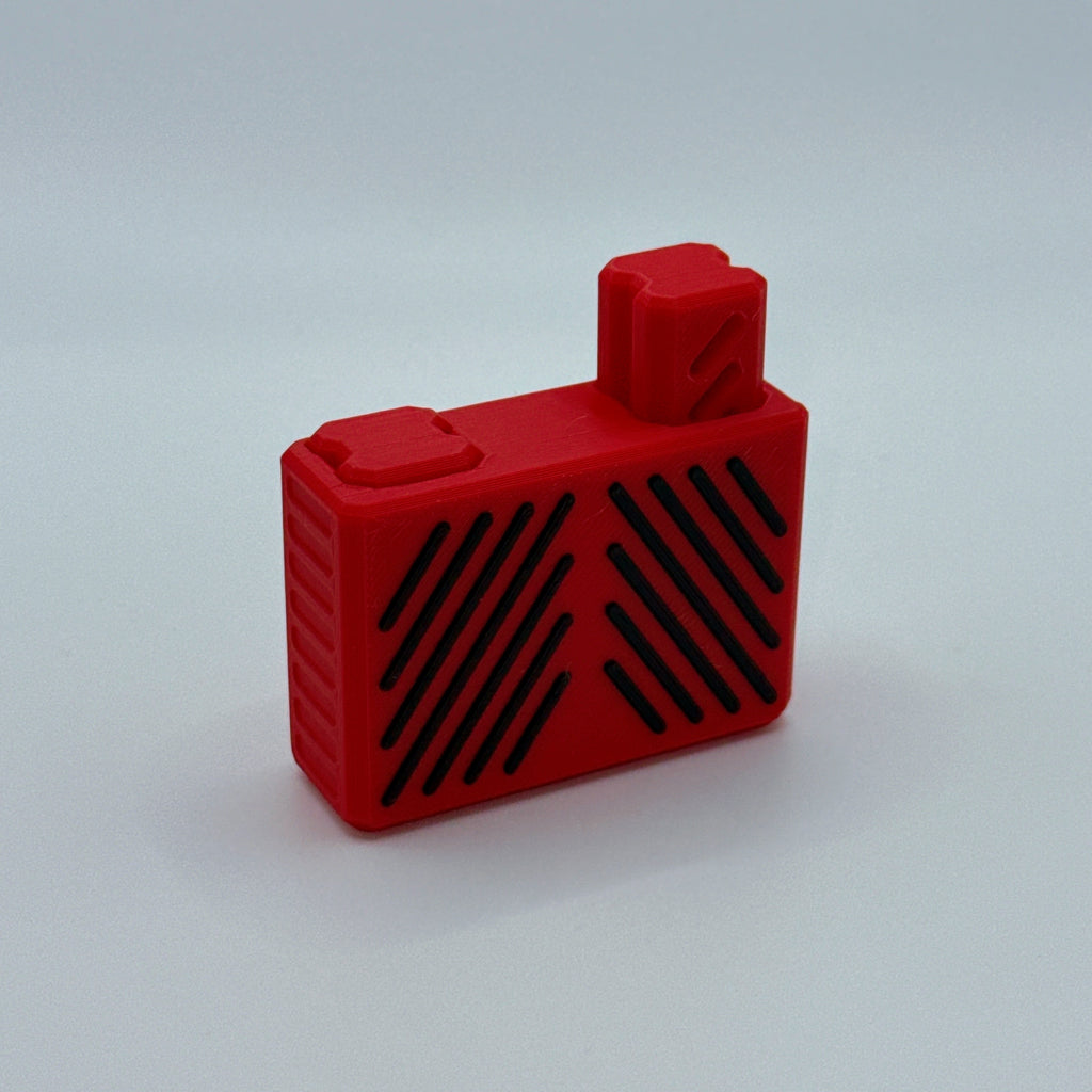 Red Clik Clak rectangular block fidget toy with black slit accents on a white background