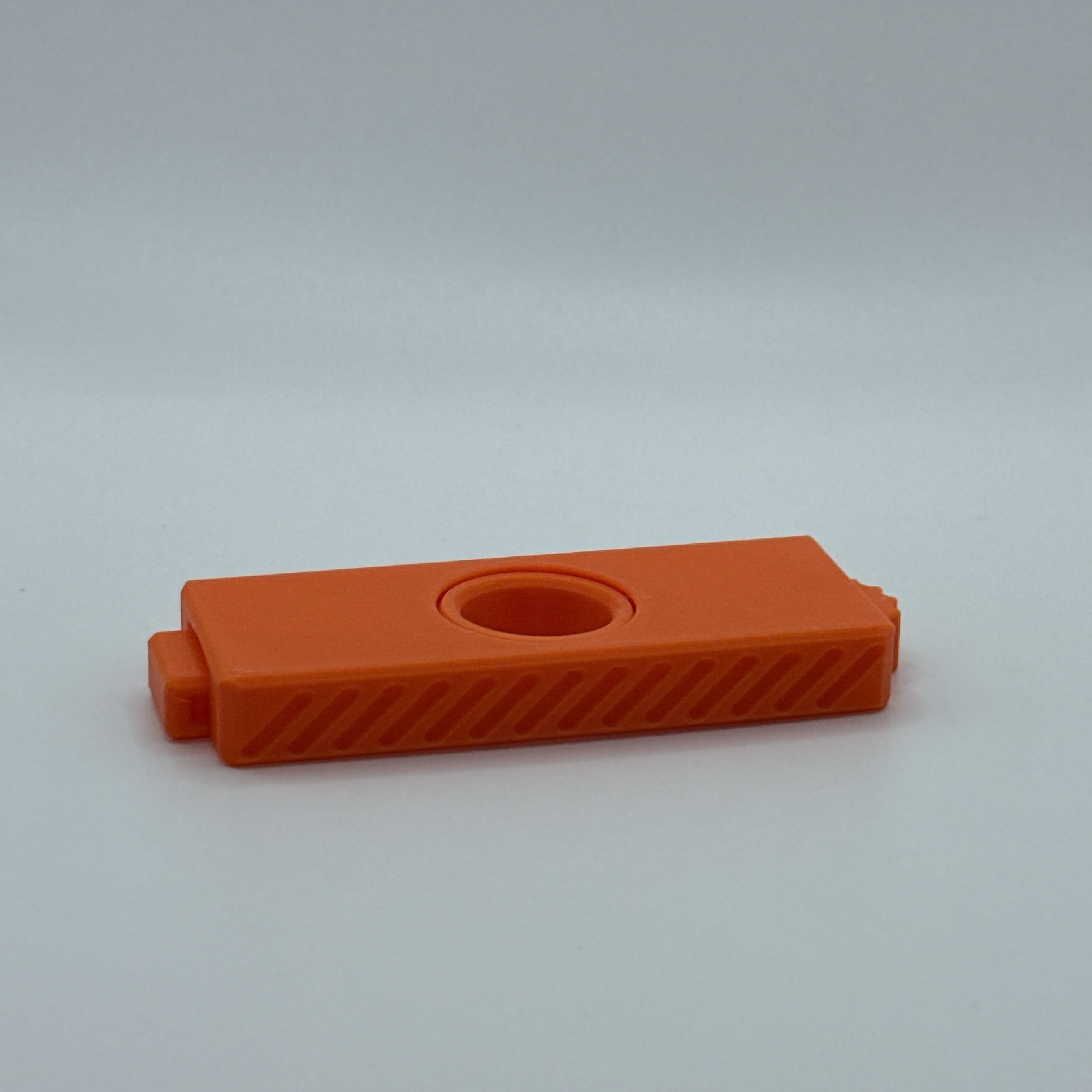 Orange Fidget Fusion fidget toy on a light gray background