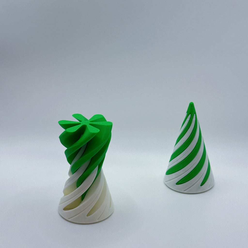 Two green and white large Spirally striped cone-shaped fidget toys (one inverted) on a gray background