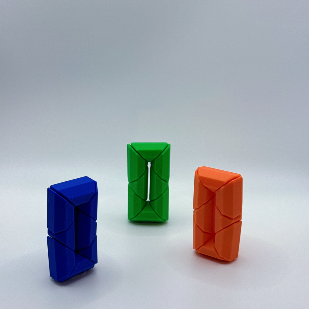 Blue, green and orange Infinite Twist hexagonal shaped fidget toy on a white background.