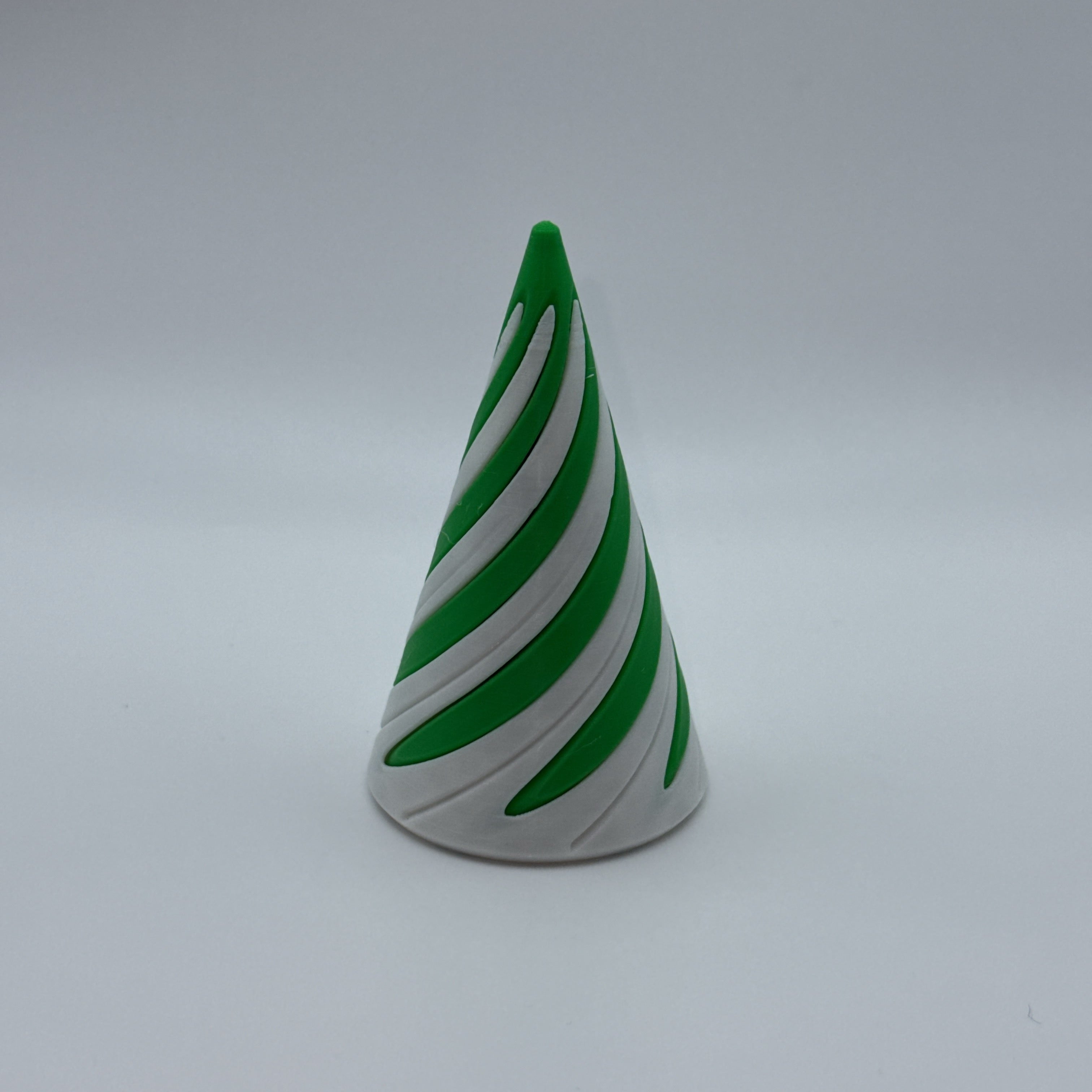 Green and white large Spirally striped cone-shaped fidget toy on a gray background