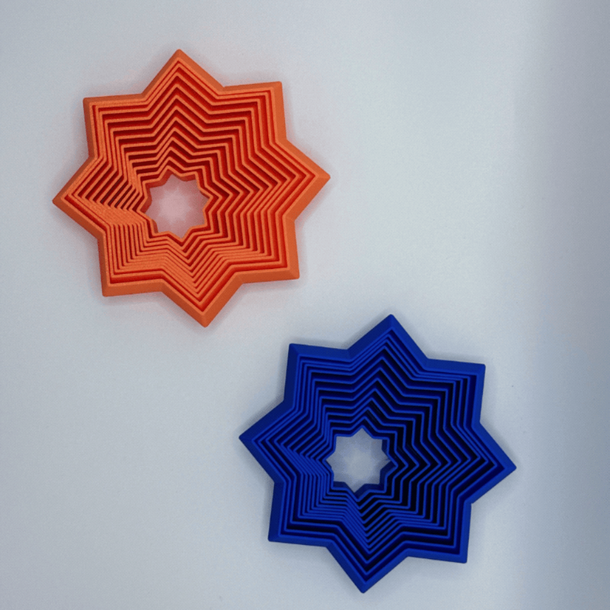 Animated orange and blue Supernova fidget toys on a white background